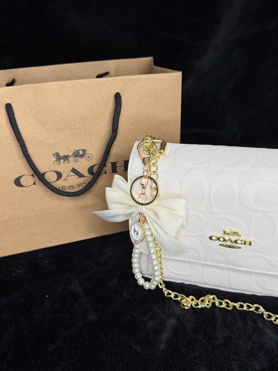 Coach Handbags - Coach Cream Signature Crossbody with Gold Chain and Bow Charm